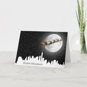 Santa and Sleigh Flying Over City Card