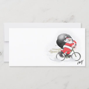 Santa bicycling with his sack in the snow. holiday card