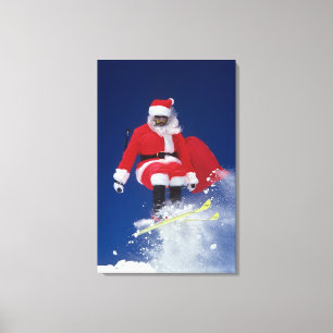 Santa Claus on skis jumping off a cornice at Canvas Print