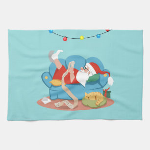 Santa Claus on the couch in pyjamas Tea Towel