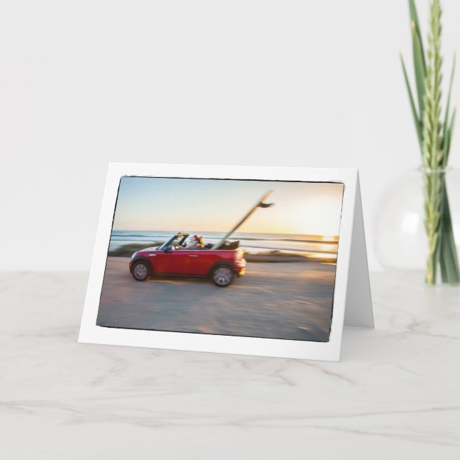 Santa driving Mini at the beach with a SUP Holiday Card (Front)