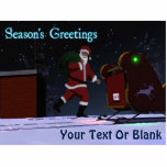 Santa On The Roof - Season's Greetings Photo Sculpture Magnet<br><div class="desc">Santa Claus is seen on the roof of a house after delivering presents. His sleigh's red and green navigation lights are reflected on the rooftop snow,  and Santa's personal North Pole license plate is visible.Text reading "Season's Greetings" also appears along with a place for your own text.</div>