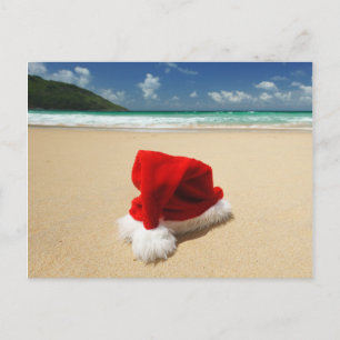 Santa's hat on a tropical beach holiday postcard