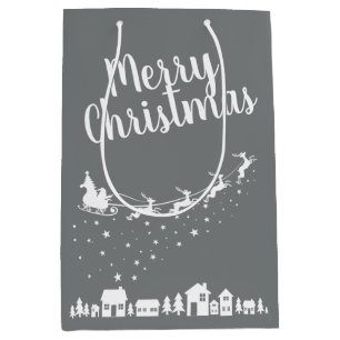 Santa's sleigh & reindeers flying above the houses medium gift bag
