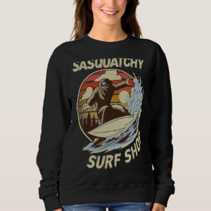 Sasquatchy Hut surfing on beach Sweatshirt