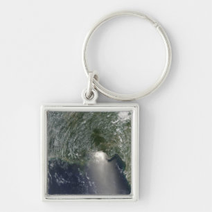Satellite view of an oil spill key ring