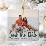 Save the Date Romantic Couple Photo Christmas Ceramic Ornament<br><div class="desc">Save the New Date written in chic bold grey typography on this romantic engagement photo Christmas ornament. Add your own full bleed couple photograph on this unique minimalist Save the Date gift and personalise the wedding details over the photograph. This modern wedding invite idea features a 2nd picture on the...</div>