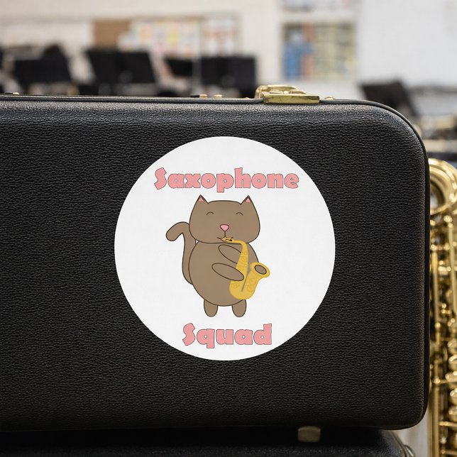 Saxophone Squad Kawaii Cat Funny Pink Classic Round Sticker (A funny sticker with a cat playing the saxophone and the text saxophone squad.)
