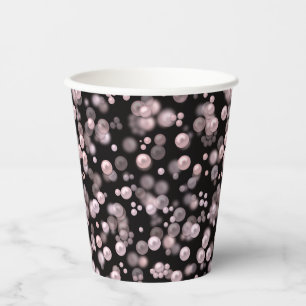 Scatterings of pink and white pearls on black velv paper cups