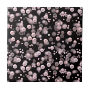Scatterings of pink and white pearls on black velv tile