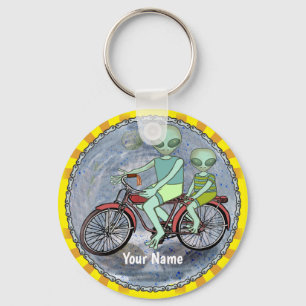 scifi Alien Riding Bike keychain