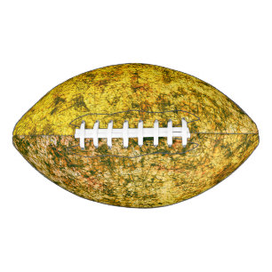 Scratches on a lightly spotted ochre yellow american football