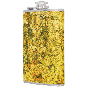 Scratches on scratches on a lightly spotted ochre hip flask