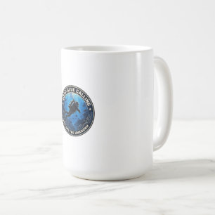 Scuba diver swimming inside a round ocean emblem. coffee mug