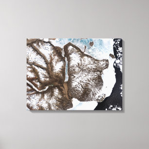 Sea ice lines the shoreline in eastern Greenlan Canvas Print