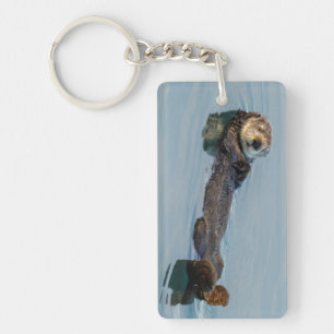 Sea otter floating on back in ocean key ring