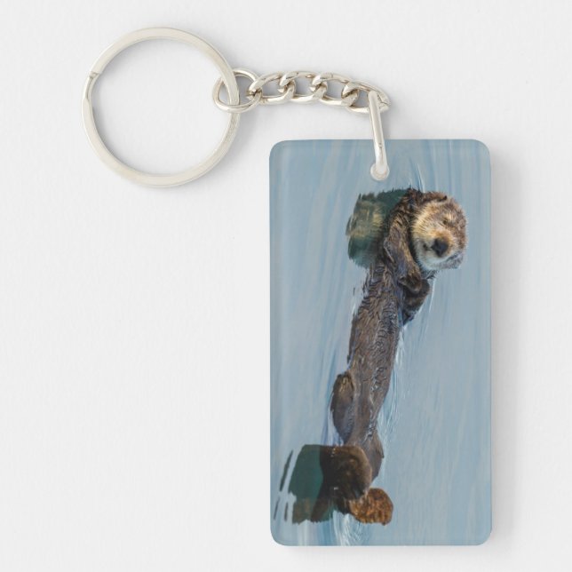 Sea otter floating on back in ocean key ring (Front)