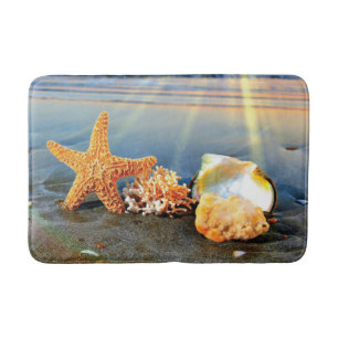 Sea shells and starfish on beach bath mat