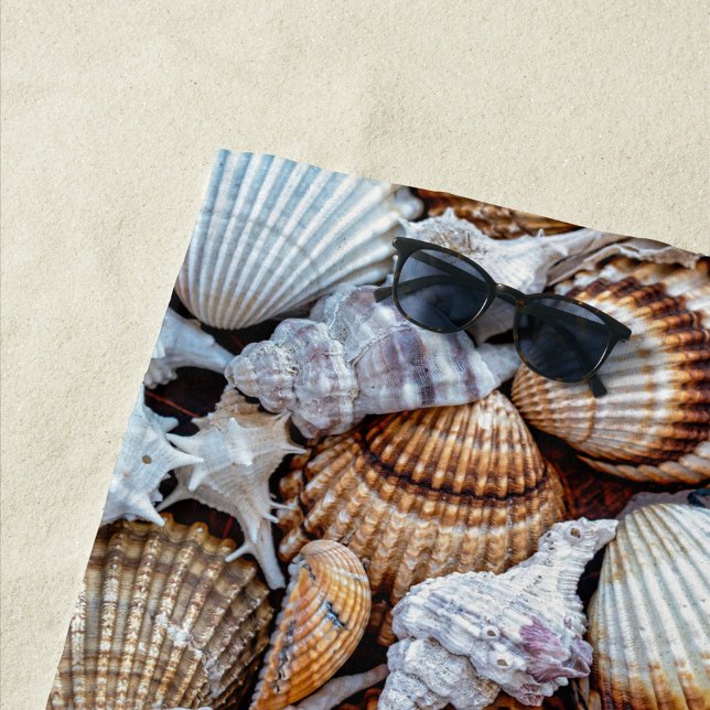 Sea Shells Beach Towel (A vibrant collection of seashells scattered across a sandy surface. )