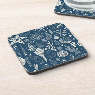 Sea shells on dark blue coaster