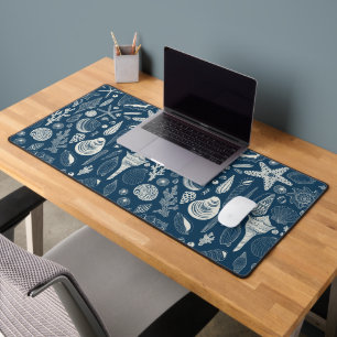 Sea shells on dark blue desk mat