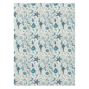 Sea shells on  off white tablecloth
