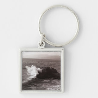 Sea waves crashing against rock key ring