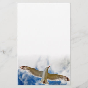Seagull gliding in flight close up with blue skies stationery