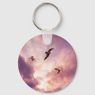 Seagulls flying in a sunset sky key ring