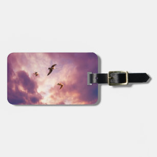 Seagulls flying in a sunset sky luggage tag