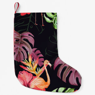 Seamless pattern of hibiscus flower, flamingos and small christmas stocking