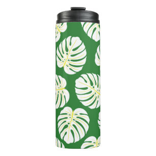 Seamless pattern of white monstera leaves on a dar thermal tumbler