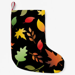Seamless pattern with autumn leaves and col small christmas stocking