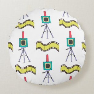 Seamless pattern with cameras and film strips on a round cushion