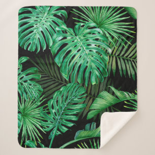 Seamless pattern with tropical leaves on a dark ba sherpa blanket