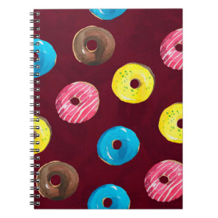 Seamless watercolor pattern with doughnuts on ruby notebook