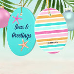 Seas & Greetings Starfish Retro Coastal Christmas Ceramic Tree Decoration<br><div class="desc">Add a vibrant splash of coastal charm to your Christmas with this 'Seas & Greetings Starfish' Christmas ornament. This eye-catching ornament captures the whimsical spirit of the holiday season and a fun beach vibe all in one. The design features pink and coral starfish and a retro font over tropical turquoise...</div>