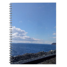 seaside and train track under blue sky