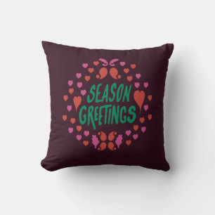 Season greetings in green handwriting with hearts cushion
