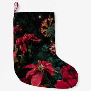 SELECTIVE FOCUS PHOTOGRAPHY OF RED POINSETTIA PLAN SMALL CHRISTMAS STOCKING