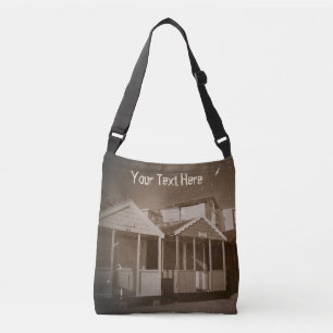 sepia pic of beach huts blue skies english seaside crossbody bag