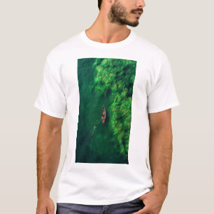 Serene Boat Sailing Through Green Seas T-Shirt