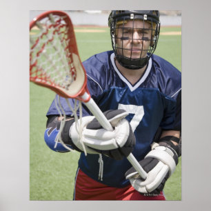 Serious lacrosse player holding crosse poster