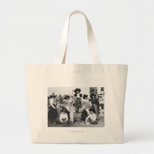 Seven rodeo cowgirls jokingly posing with a donkey large tote bag