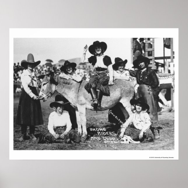 Seven rodeo cowgirls jokingly posing with a donkey poster (Front)