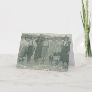 Seven rodeo cowgirls posing for a photograph. card