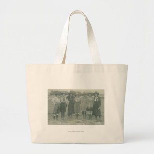 Seven rodeo cowgirls posing for a photograph. large tote bag