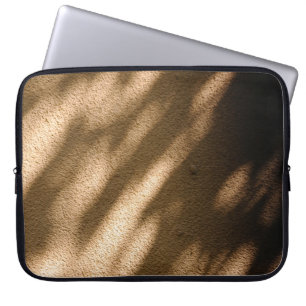 Shadow on brown carpeted floor laptop sleeve