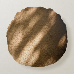 Shadow on brown carpeted floor round cushion