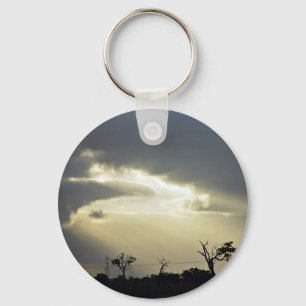 Shafts of sunlight through clouds key ring